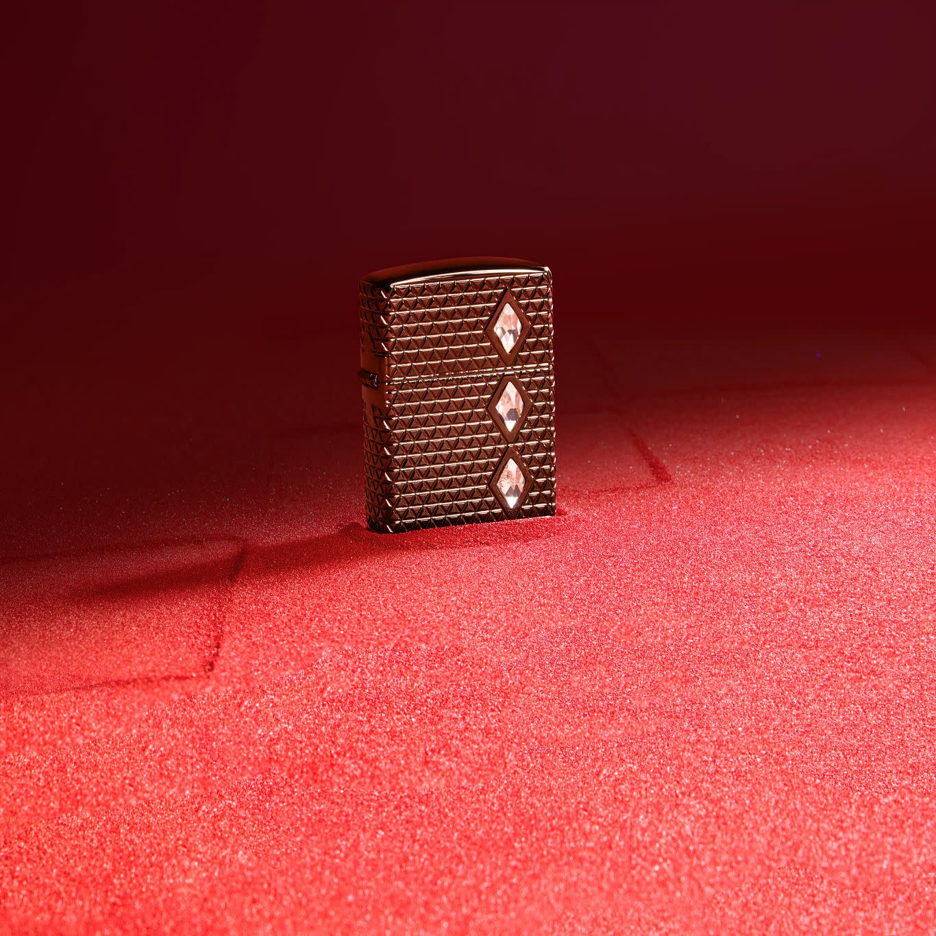 Lifestyle image of Zippo Diamond Pattern Design Armor® Black Ice® Windproof Lighter standing on red sand.