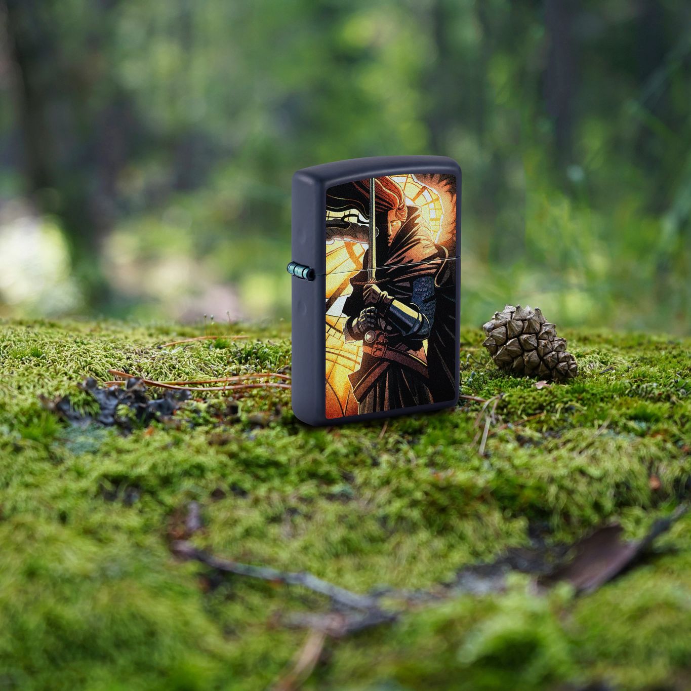 Lifestyle image of Zippo Abstract Knight Design Navy Matte Windproof Lighter standing on moss covered ground next to a pinecone and pine needles with a blurred forest background.