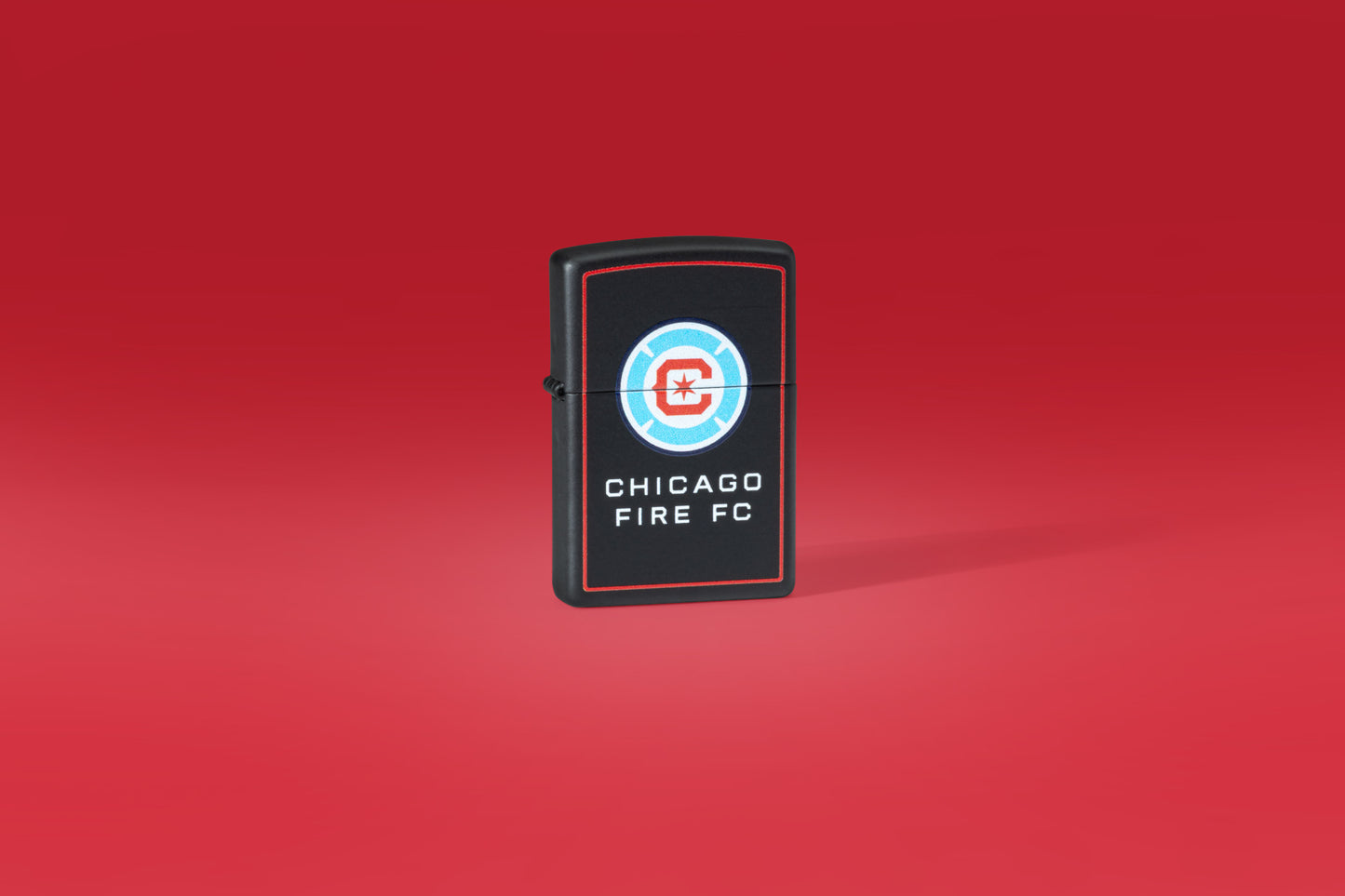 Lifestyle image on Red Background of Chicago Fire FC Windproof Lighter