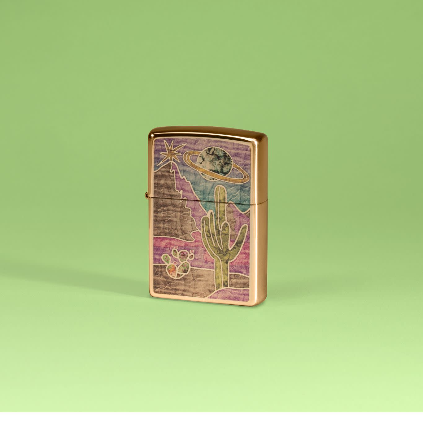 Lifestyle image of Zippo Funky Western Fusion Polish Brass Windproof Lighter on a pale green background.