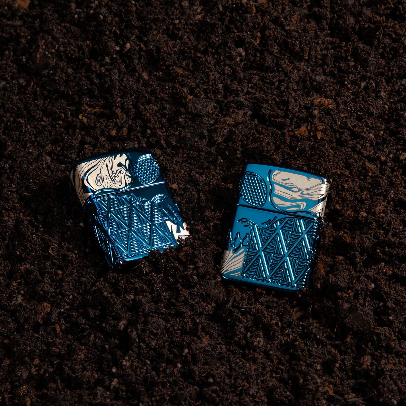 Lifestyle image of Skull Design Armor® High Polish Blue Windproof Lighter laying in the dirt.
