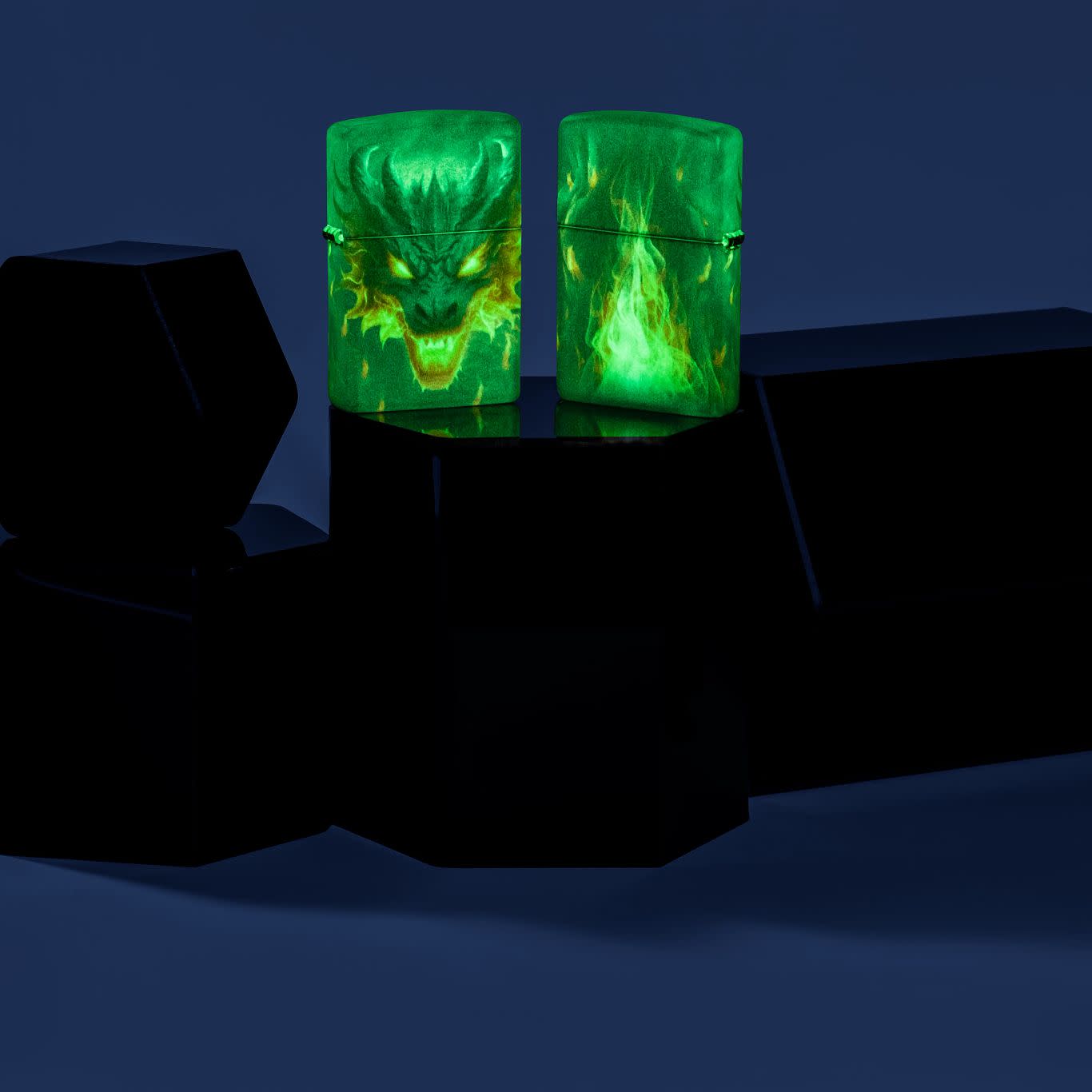 Lifestyle image of two Zippo Glowing Dragon Design 540 Color Glow in the Dark Windproof Lighters glowing in the dark and standing on a hexagonal prism.