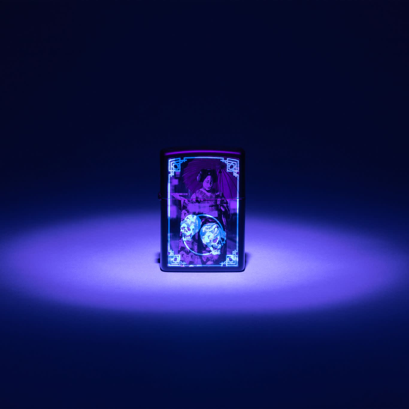 Lifestyle image of Zippo Black Light Cyber Kimono Design Black Matte Windproof Lighter glowing under a black light.