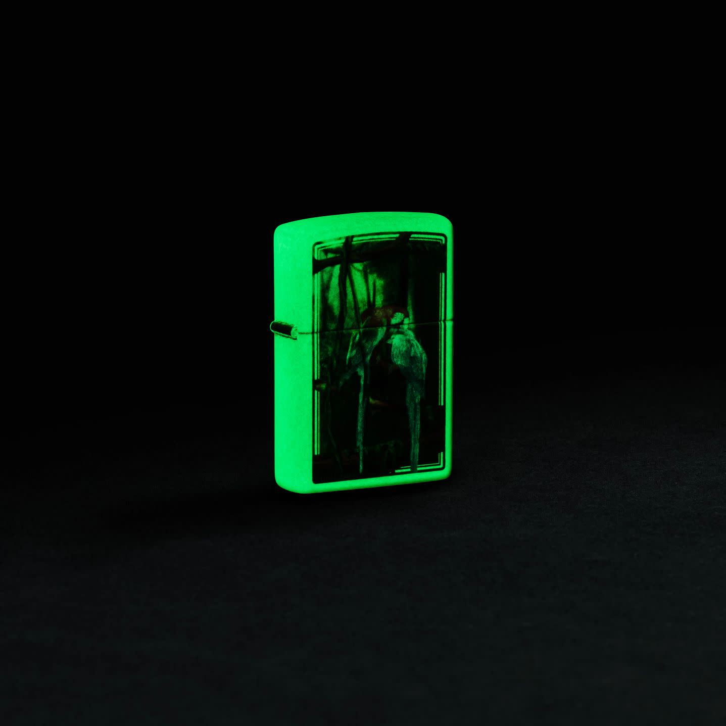 Lifestyle image of Zippo Carol Cavalaris Glow in the Dark Windproof Lighter glowing in the dark.
