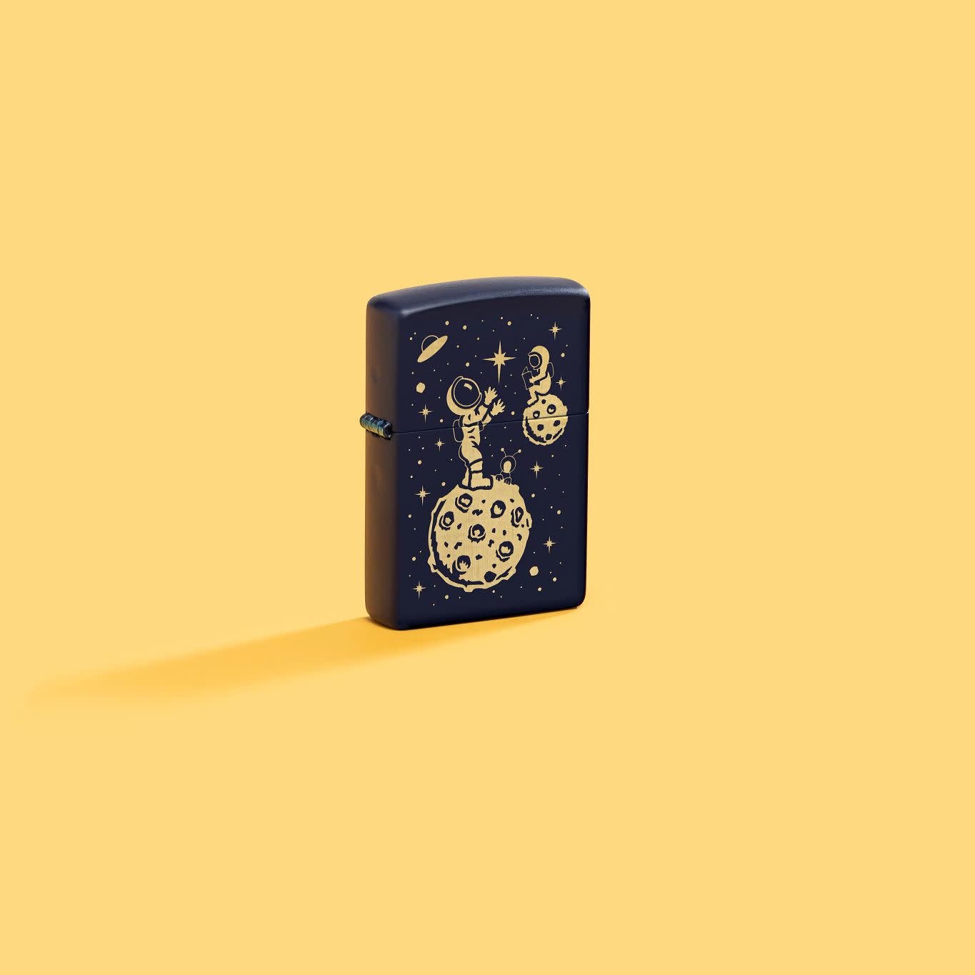 Lifestyle image of Zippo Lost in Space Design Navy Matte Windproof Lighter standing in a yellow scene.