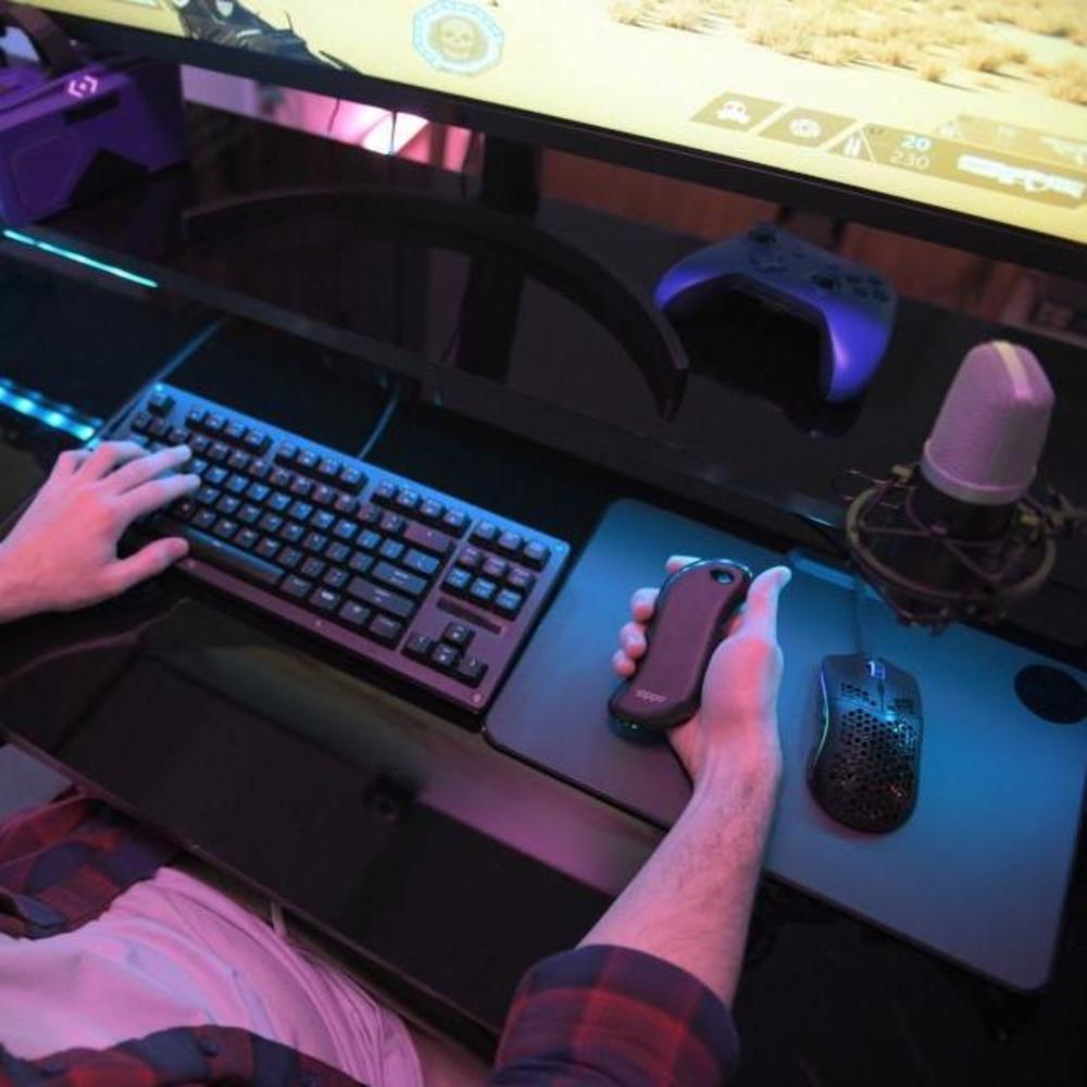 Lifestyle image of Black HeatBank® 9s Rechargeable Gaming Hand Warmer in hand while gaming.