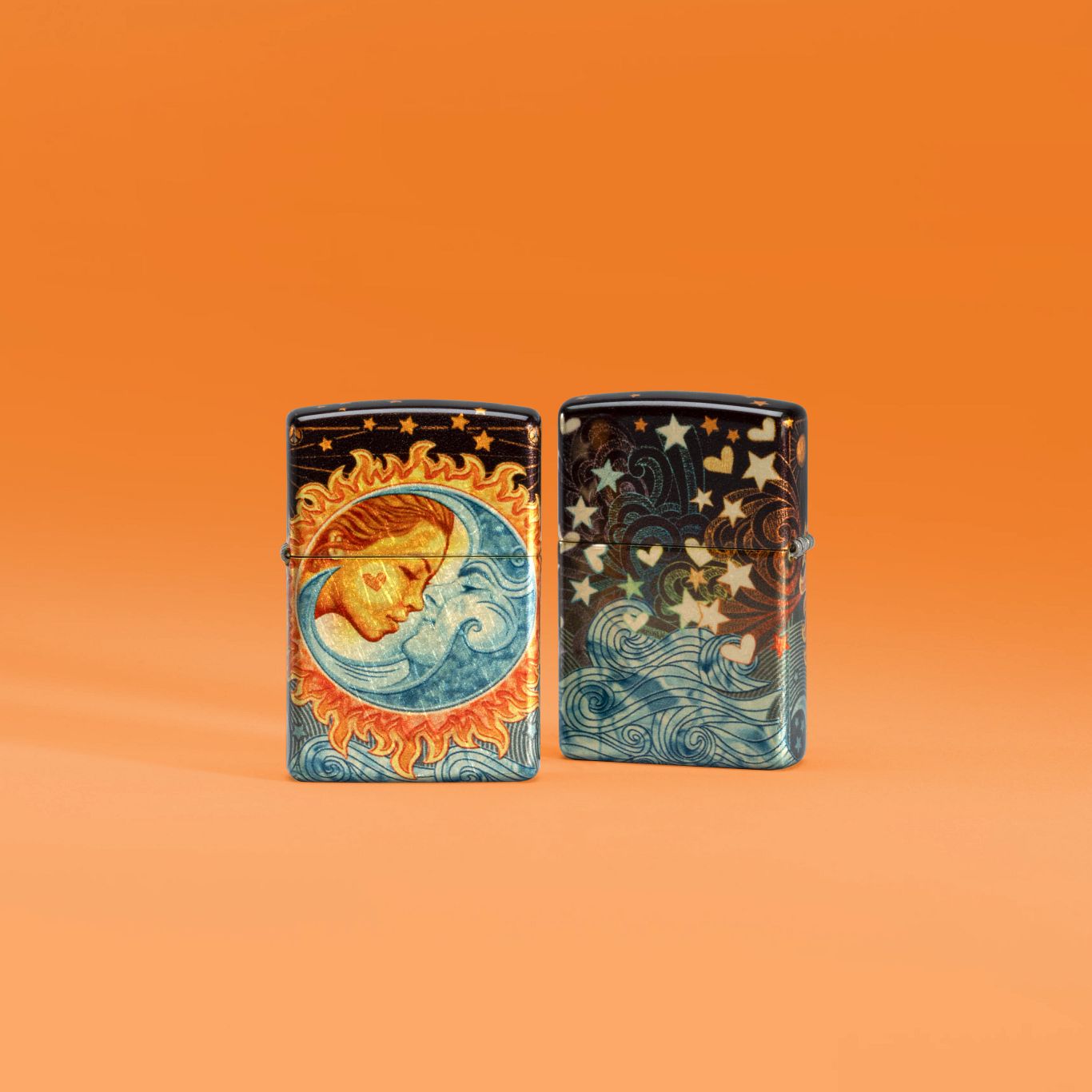 Lifestyle image of two Zippo Celestial Sweethearts Design 540 Tumbled Brass Windproof Lighters, one showing the front of the lighter and the other showing the back, set against an orange background.