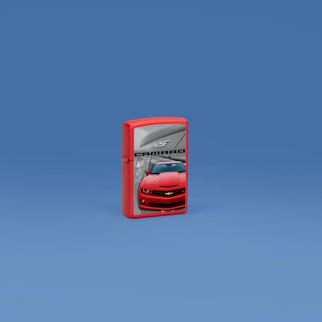 Lifestyle image of Zippo Chevrolet® Camaro Design Red Matte Windproof Lighter standing with a denim blue background.
