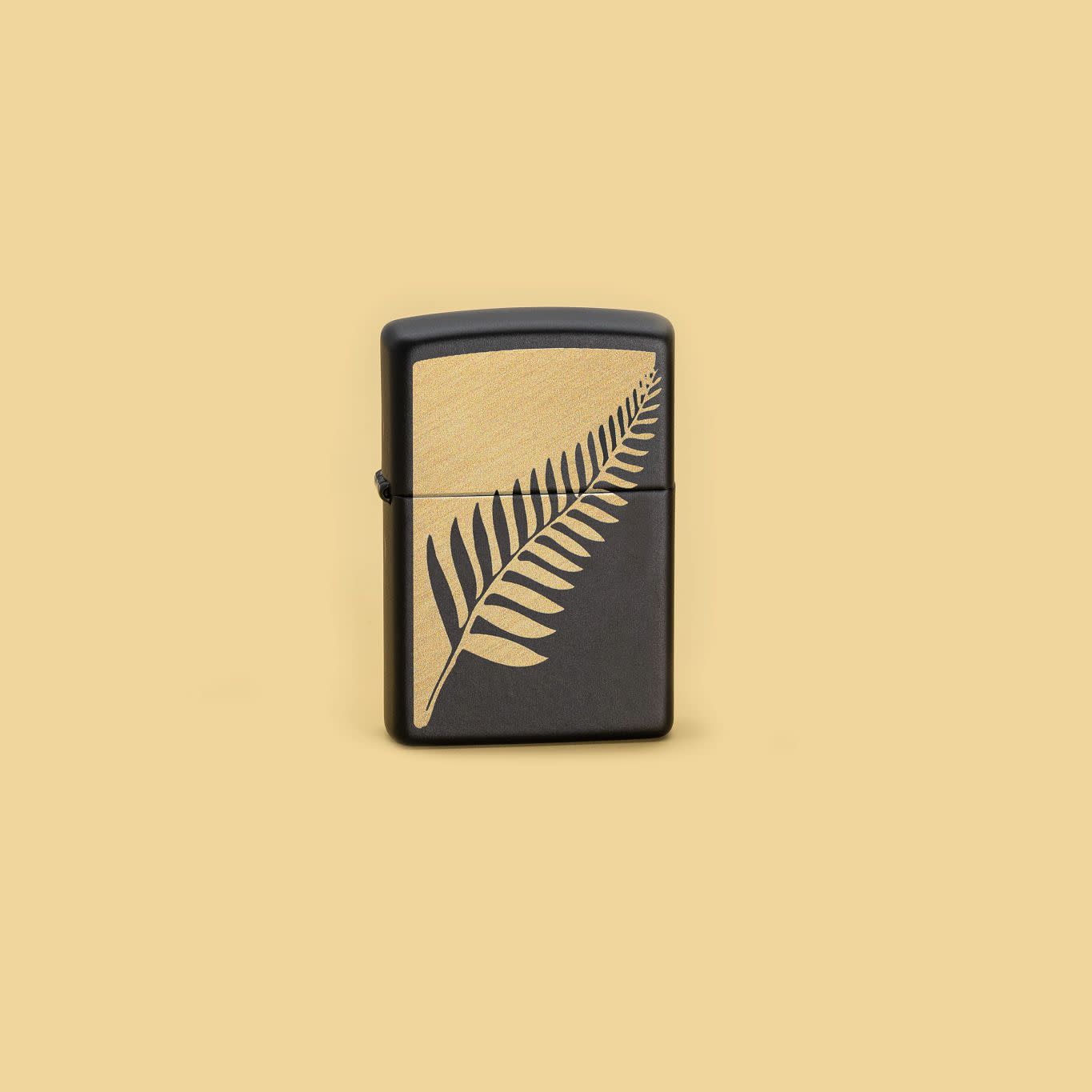 Lifestyle image of Zippo Zen Flora Design Black Matte Windproof Lighter in a yellow scene.