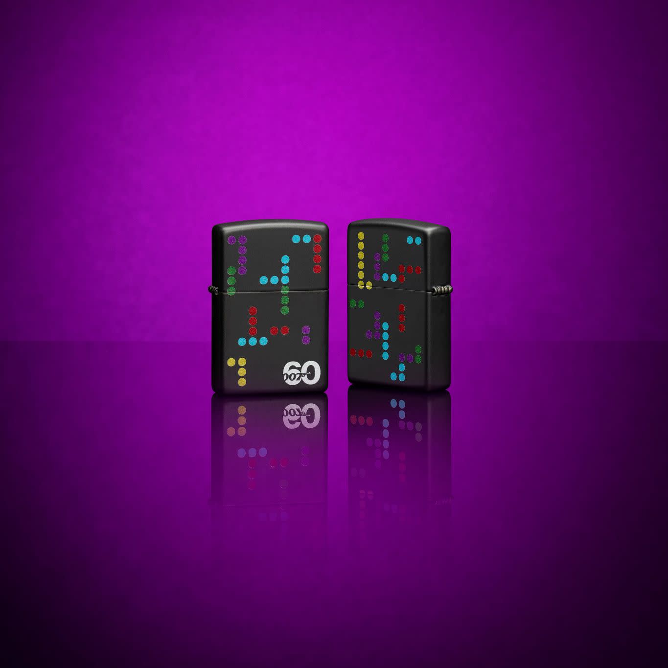 Glamour shot of two James Bond 007â„¢ 60th Anniversary Black Matte Windproof Lighters in a purple scene.