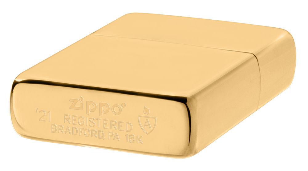 Armor® High Polish 18K Solid Gold Windproof Lighter laying down at an angle, showing the genuine bottom stamp.