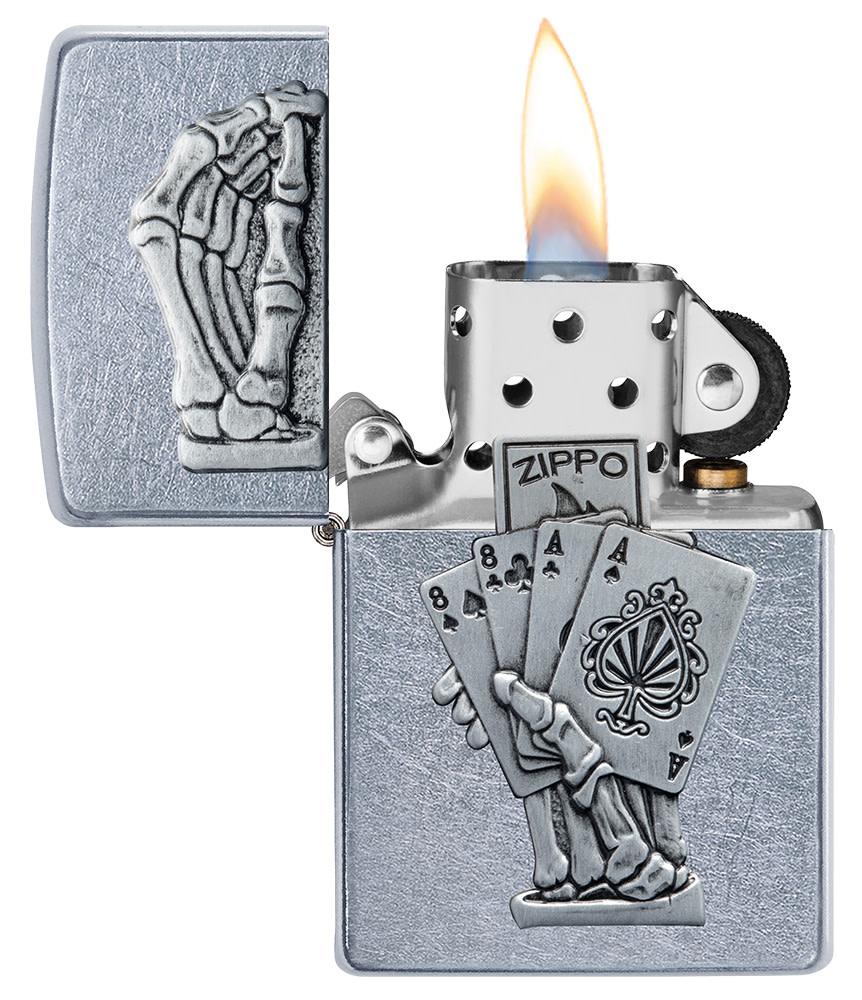 Dead Mans Hand Surprise Emblem Design Street Chromeâ„¢ Windproof Lighter with its lid open and lit