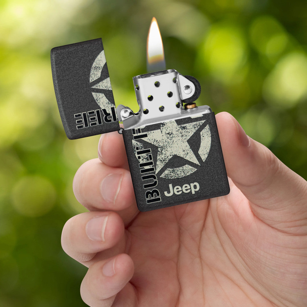 Zippo Jeep® Freedom Star Design Black Crackle Windproof Lighter lit in hand.