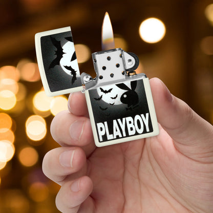 Zippo Playboy Glowing Bats Design Glow In The Dark Windproof Lighter lit in hand.