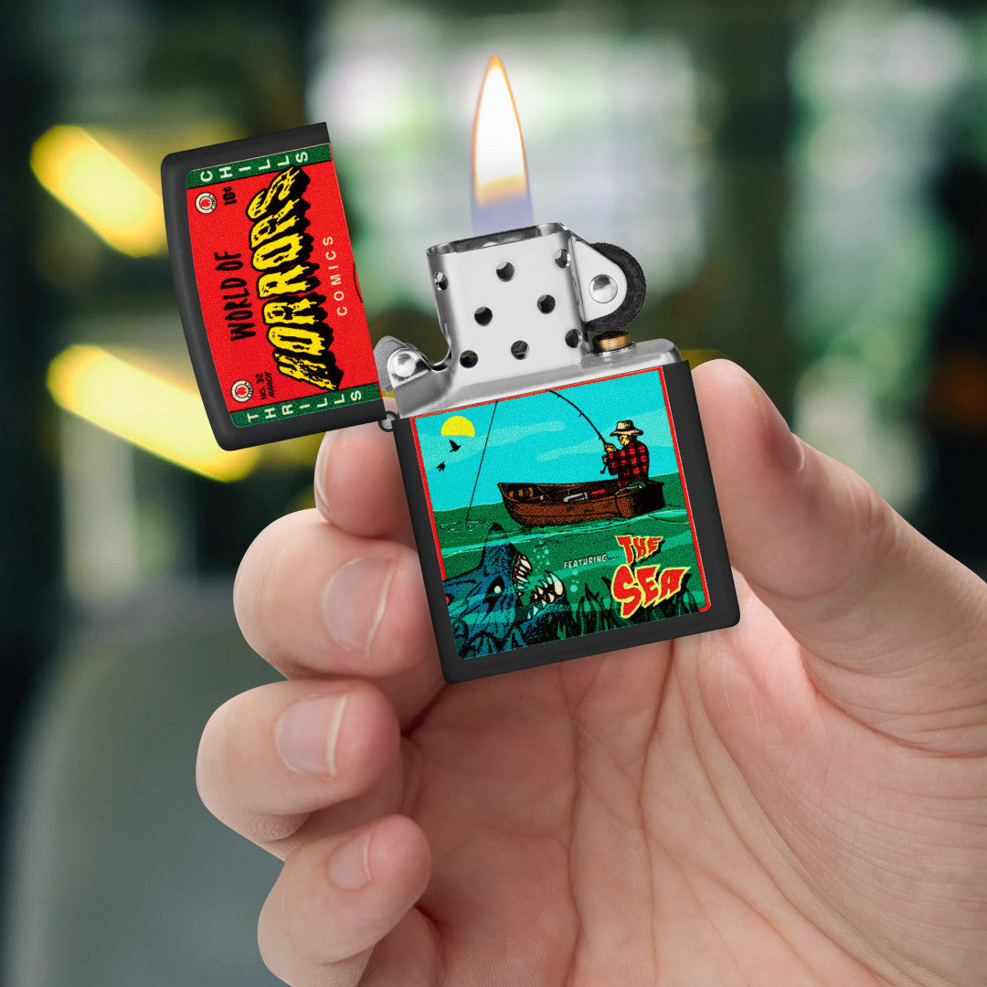 Zippo In Deep Trouble Design Black Matte Windproof Lighter lit in hand.