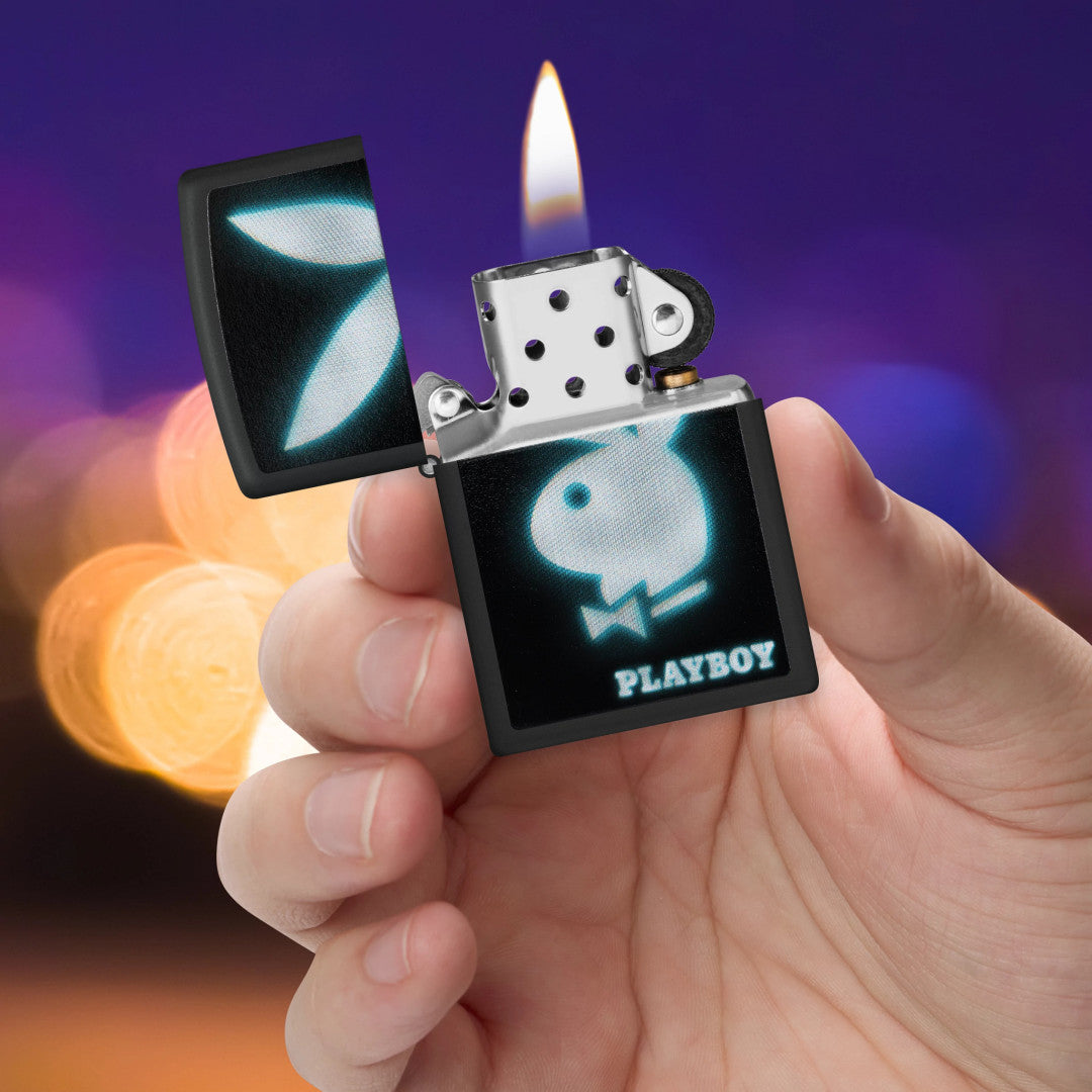 Zippo Playboy Blur Design Black Matte Windproof Lighter lit in hand.