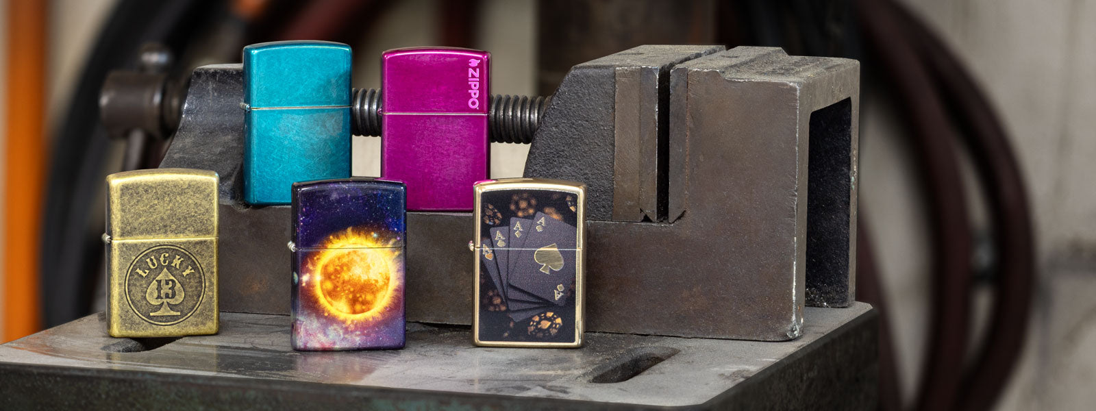 Collection of colorful lighters on a metal surface with a blurred background