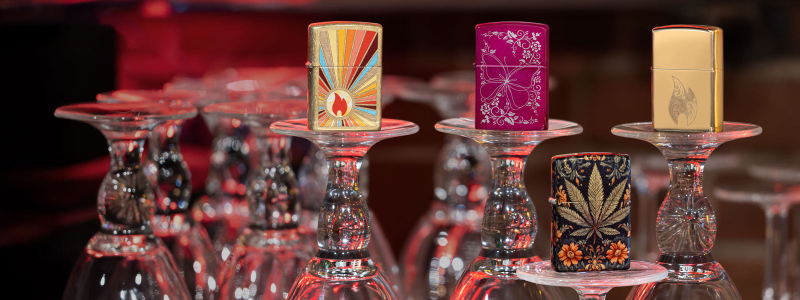 Four lighters on display on wine glasses.
