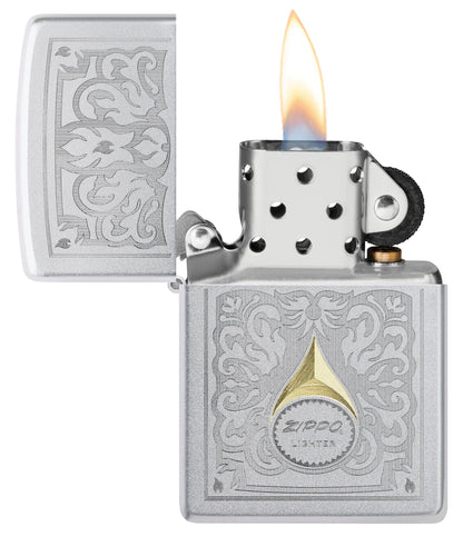 Zippo Vintage Filigree Design Satin Chrome Windproof Lighter with its lid open and lit.