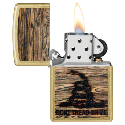 Zippo Don't Tread On Me® Woodburn Design Street Brass Windproof Lighter with its lid open and lit.