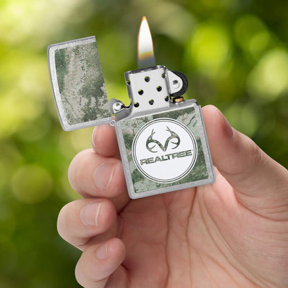 Zippo Realtree® XTREME Design Street Chrome Windproof Lighter lit in hand.