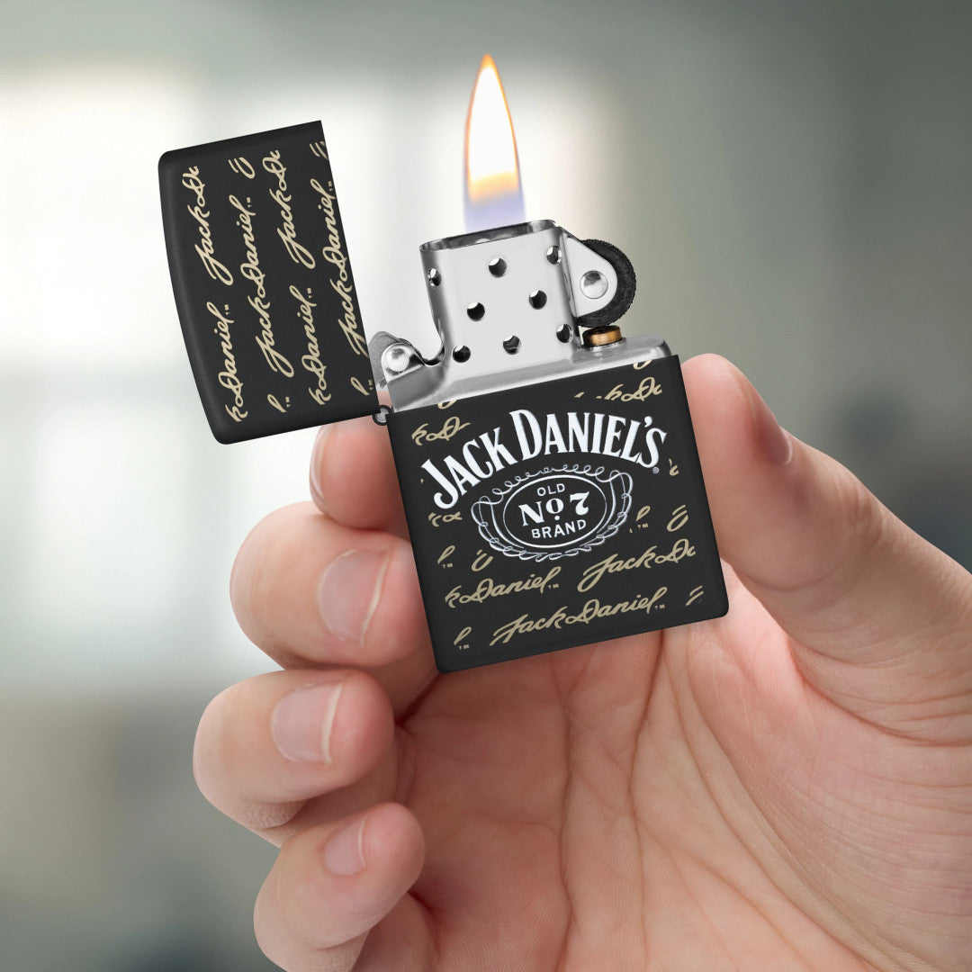 Zippo Jack Daniel's Signature Design Black Matte Windproof Lighter lit in hand.