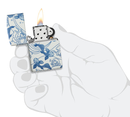 Zippo Porcelain Koi Design 540 Matte Windproof Lighter lit in hand.