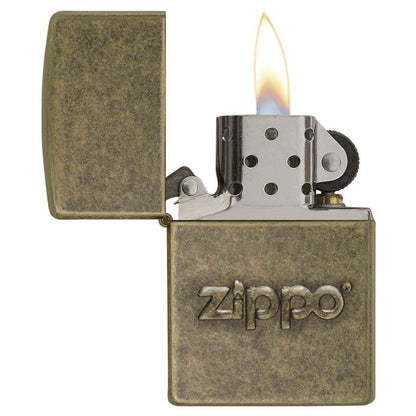 Zippo Stamp Antique Brass Lighter with its lid open and lit.