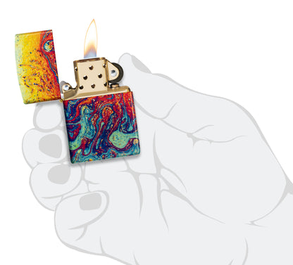 Zippo Magma Fusion Design 540 Tumbled Brass Windproof Lighter lit in hand.