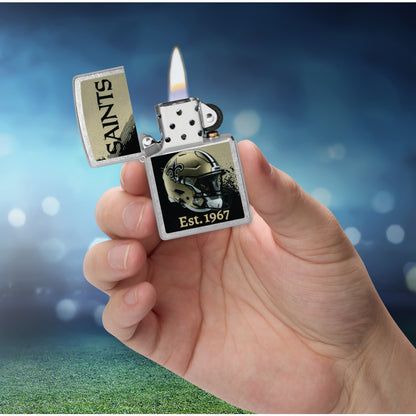 Zippo NFL New Orleans Saints Helmet Design Street Chrome Windproof Lighter lit in hand.