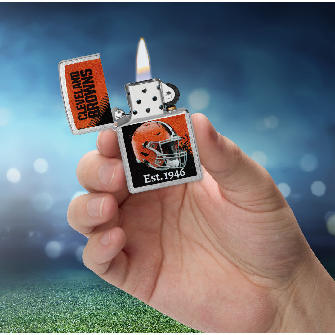 Zippo NFL Cleveland Browns Helmet Design Street Chrome Windproof Lighter lit in hand.