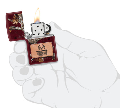 Zippo Realtree® Edge® Colors Design Merlot Windproof Lighter lit in hand.