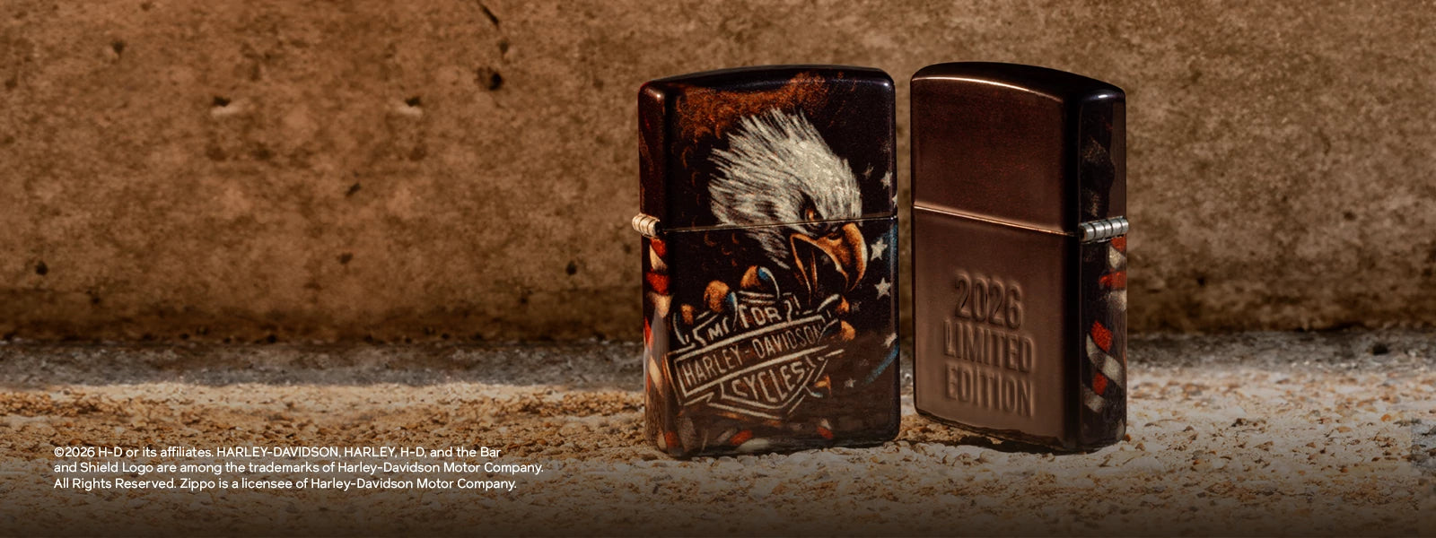 Two Zippo lighters decorated with a Harley Davidson design