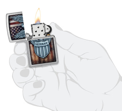 Zippo Veteran Crest Design Street Chrome Windproof Lighter lit in hand.