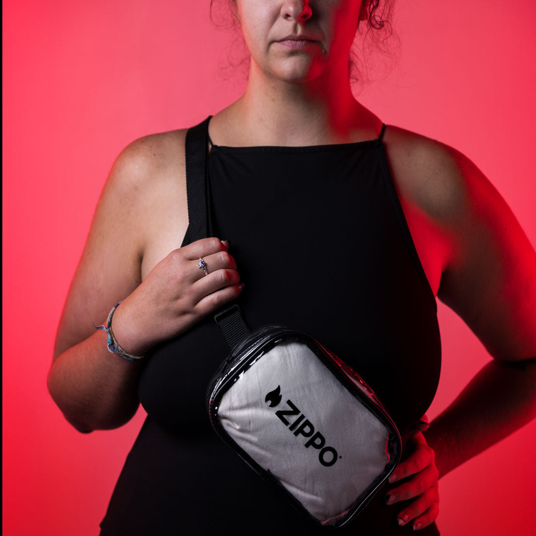 Person holding a Zippo bag against a red background