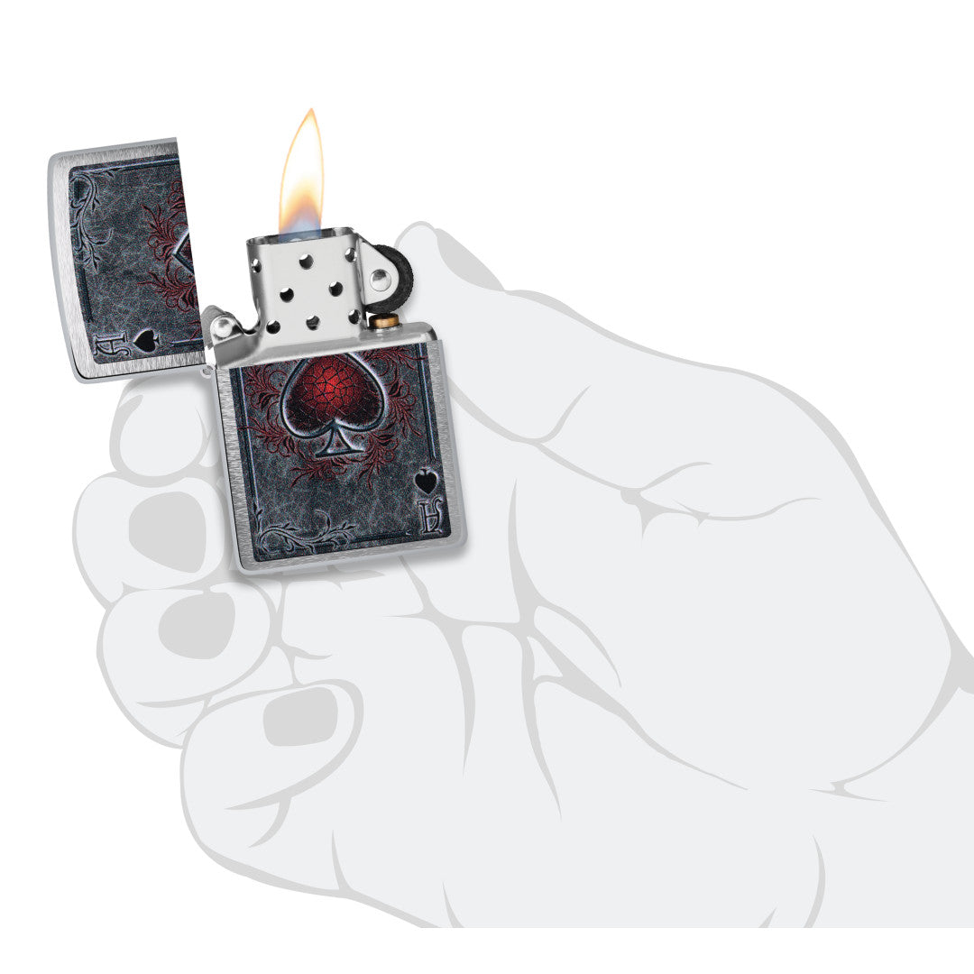 Zippo Antiqued Ace Design Brushed Chrome Windproof Lighter lit in hand.