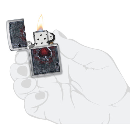 Zippo Antiqued Ace Design Brushed Chrome Windproof Lighter lit in hand.