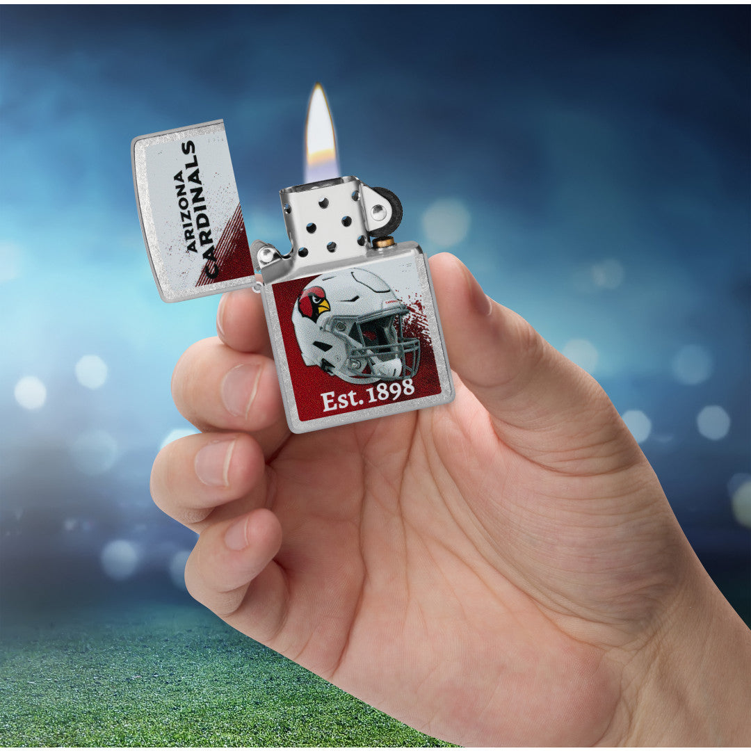 Zippo NFL Arizona Cardinals Helmet Design Street Chrome Windproof Lighter lit in hand.
