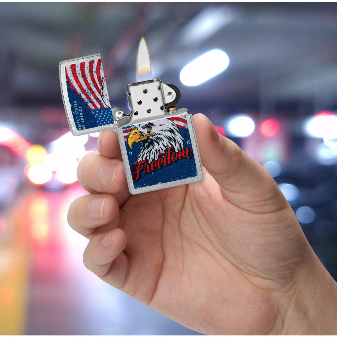 Zippo Freedom Eagle Design Street Chrome Windproof Lighter lit in hand.