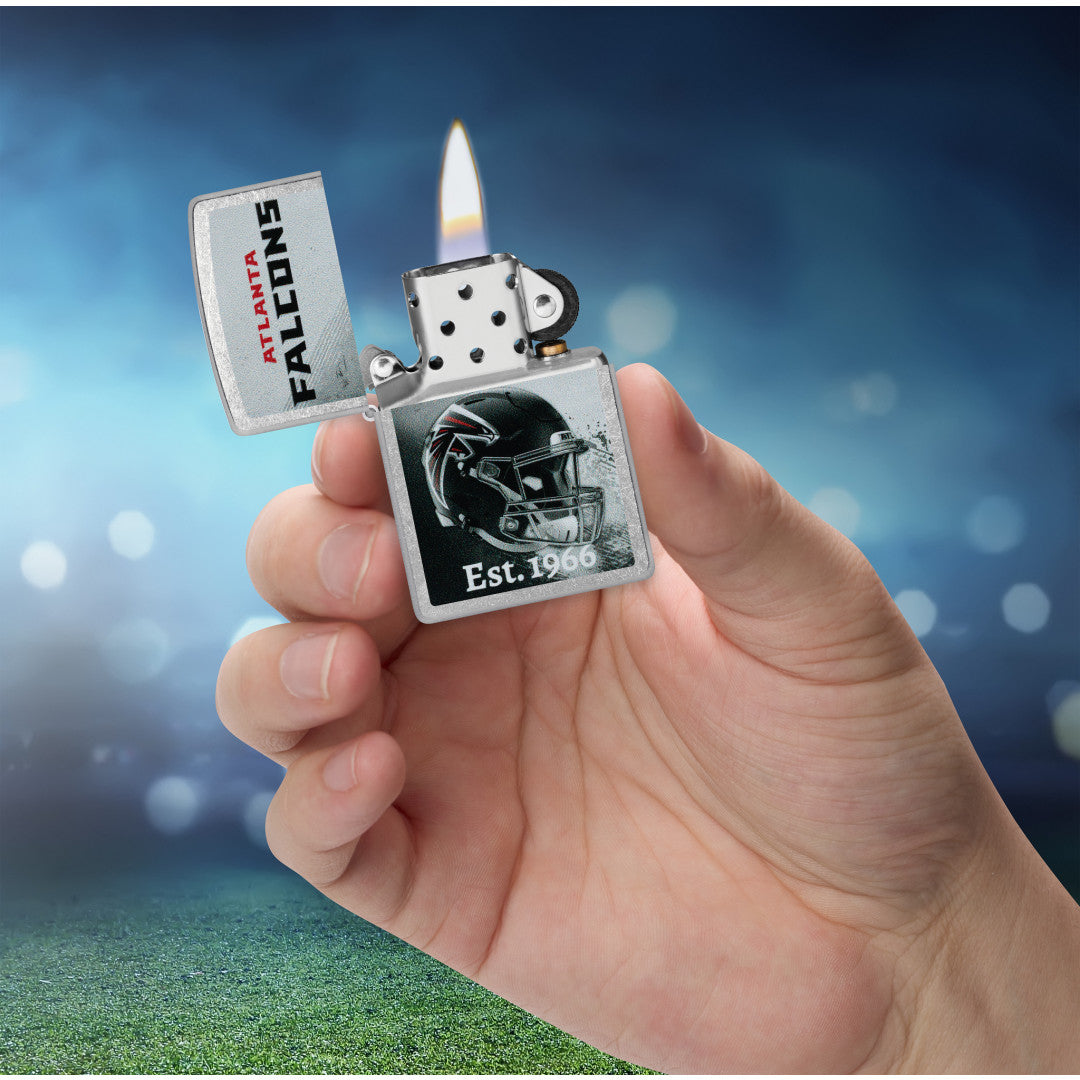 Zippo NFL Atlanta Falcons Helmet Design Street Chrome Windproof Lighter lit in hand.