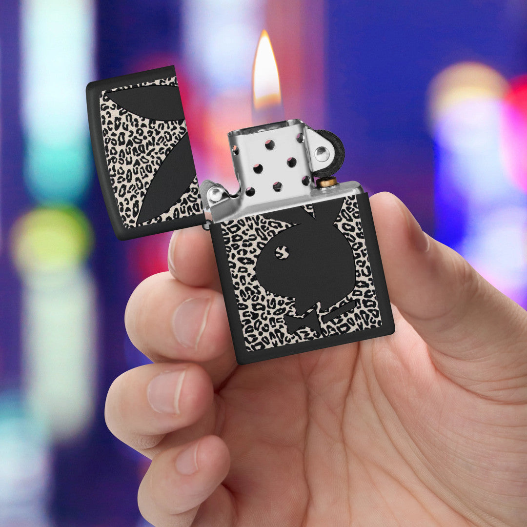 Zippo Playboy Cheetah Print Design Black Matte Windproof Lighter lit in hand.