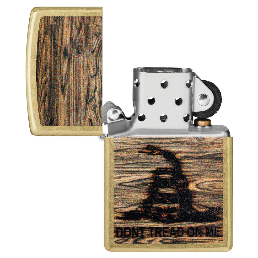 Zippo Don't Tread On Me® Woodburn Design Street Brass Windproof Lighter with its lid open and unlit.