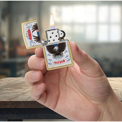 Zippo Soaring Freedom Design Street Brass Windproof Lighter lit in hand.