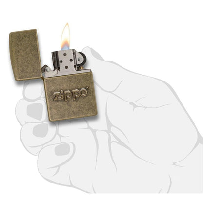 Zippo Stamp Antique Brass Lighter lit in hand.