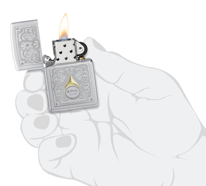 Zippo Vintage Filigree Design Satin Chrome Windproof Lighter lit in hand.