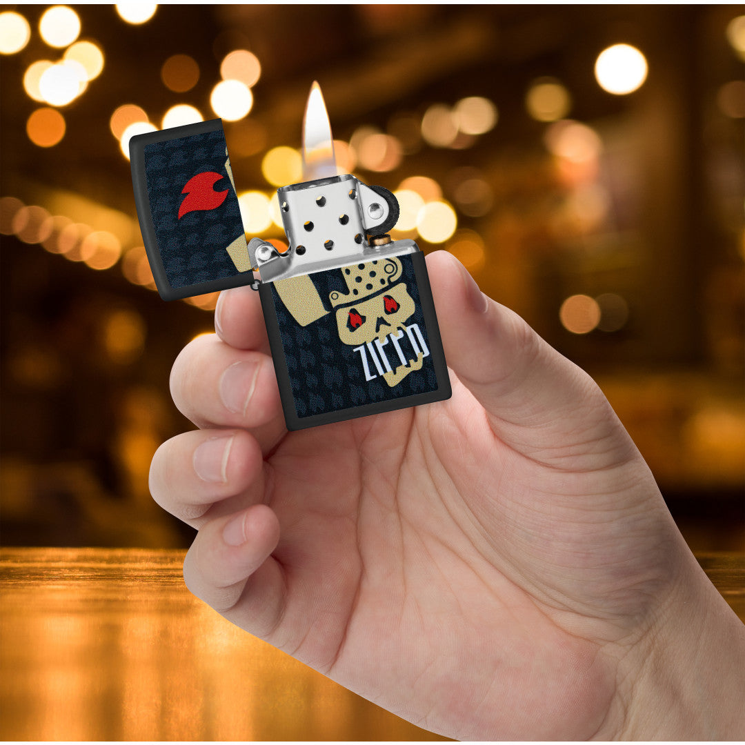 Zippo Skull and Flames Design Black Matte Windproof Lighter lit in hand.
