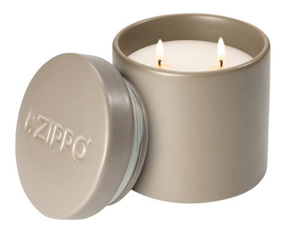 Front view of Zippo FlameScapes™ Citronella, Spearmint and Lemongrass Essential Oil Outdoor Candle lit with the lid leaning against the candle.
