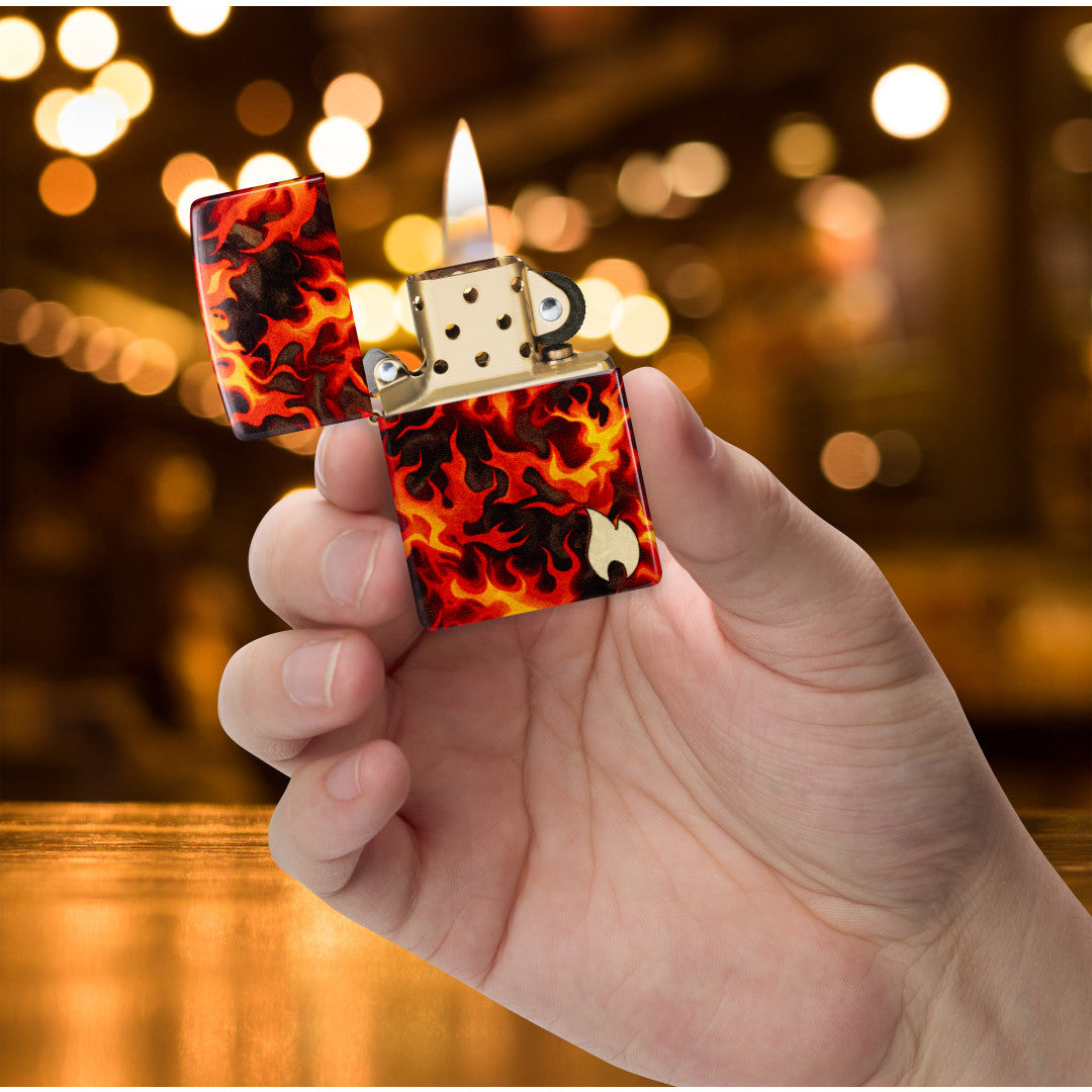 Zippo Inferno Design 540 Matte Windproof Lighter lit in hand.