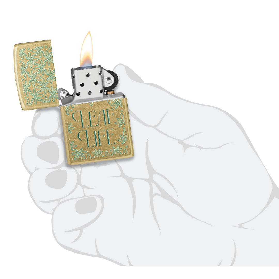 Zippo Leaf Life Design Street Brass Windproof Lighter lit in hand.