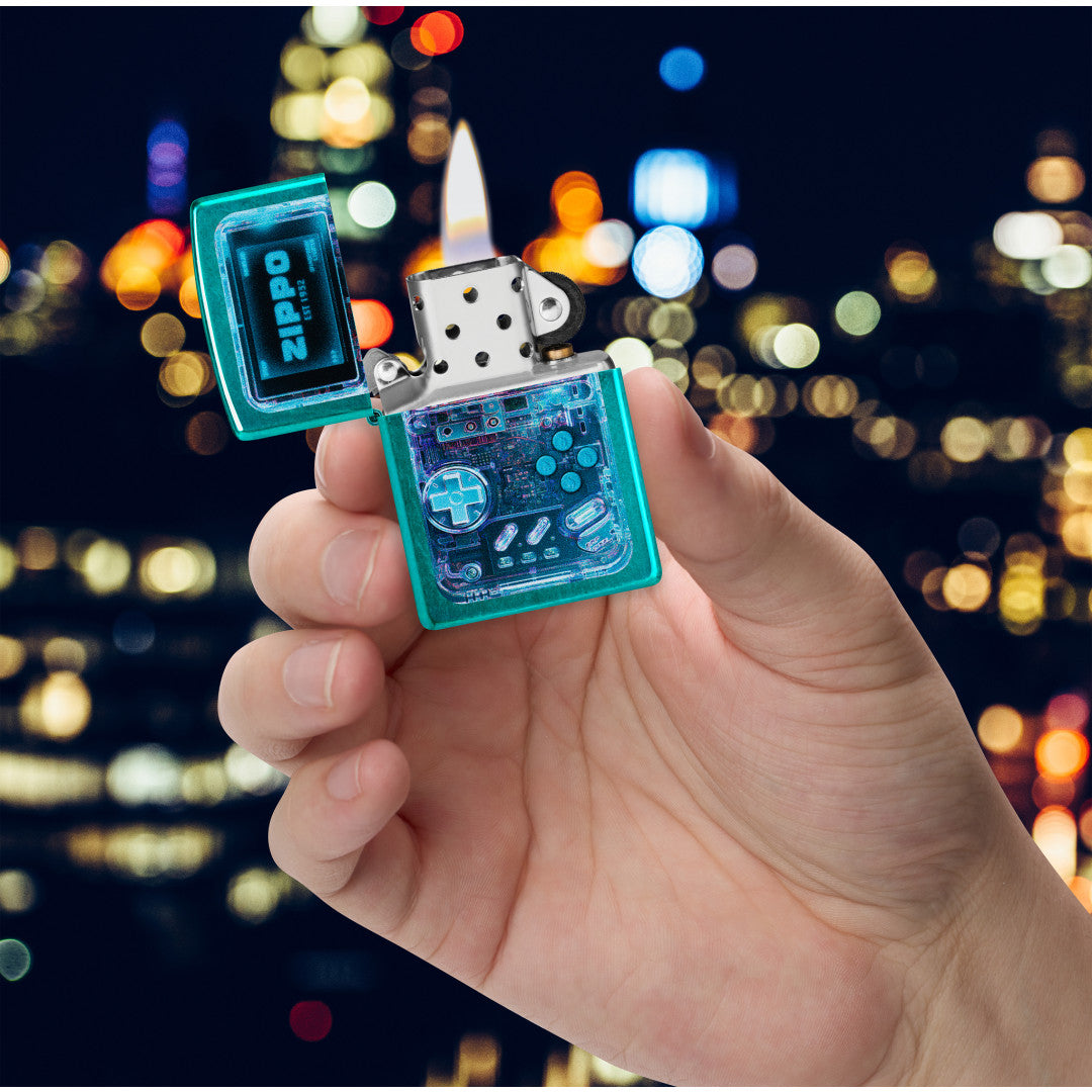Zippo Game On Design Candy Teal Windproof Lighter lit in hand.